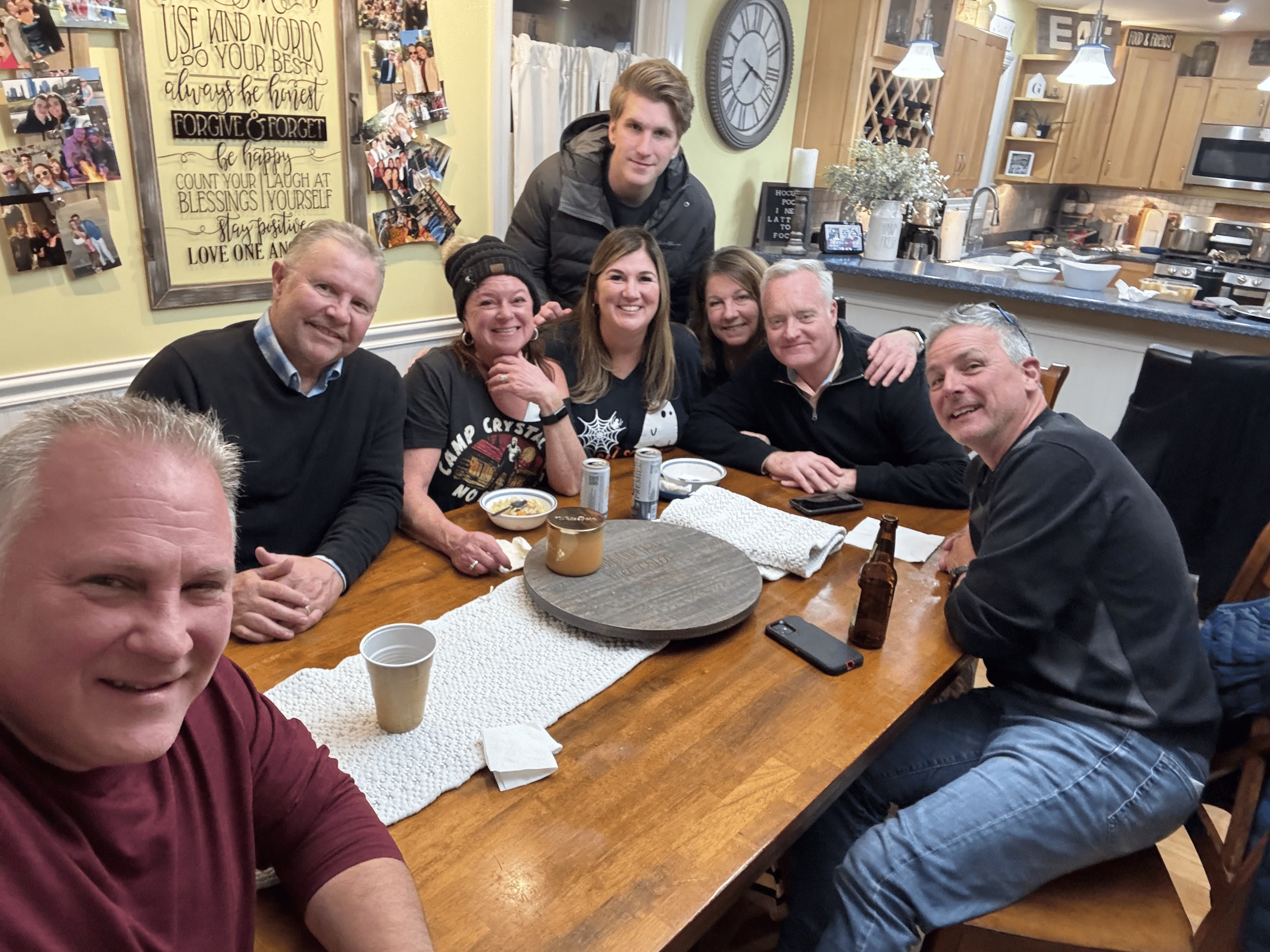 Ray Schellenberger with family gathered around a kitchen table